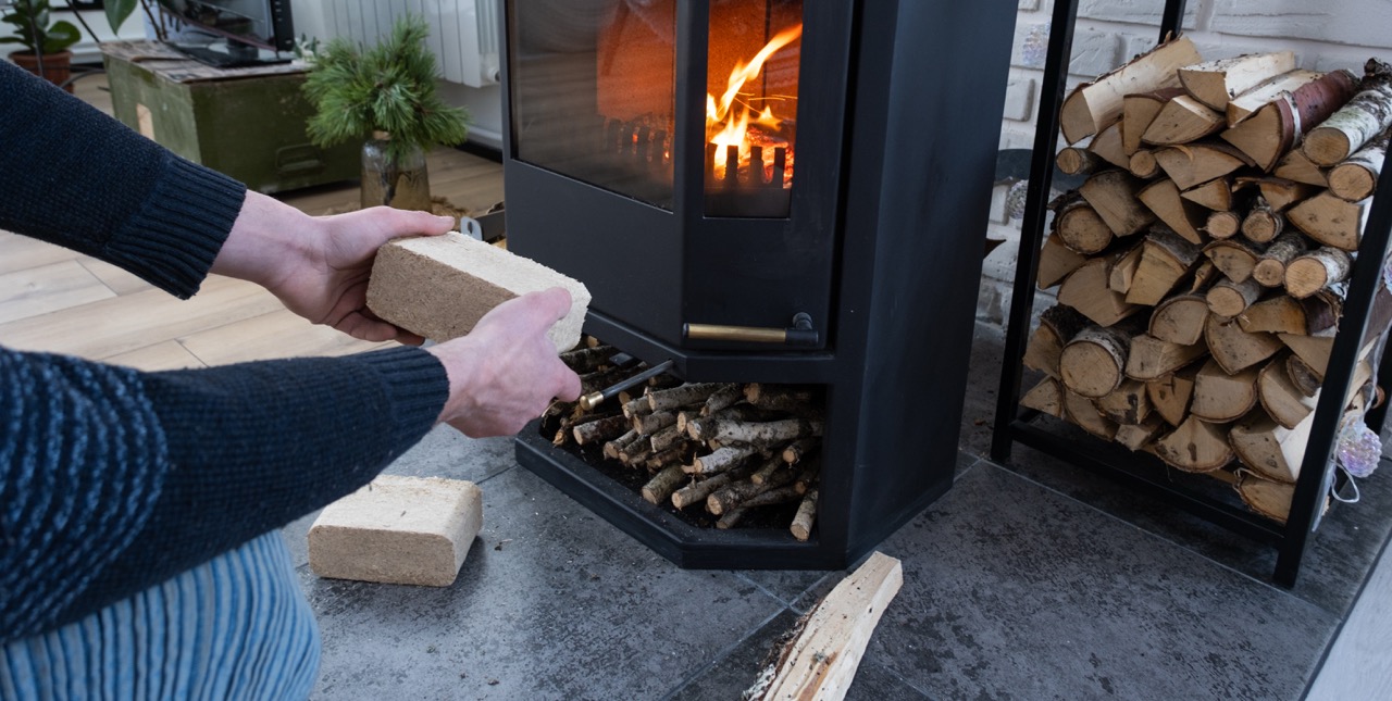 person adding wood brick to fireplace for warmth 2026 09 21 02 20 47 utc Duzy